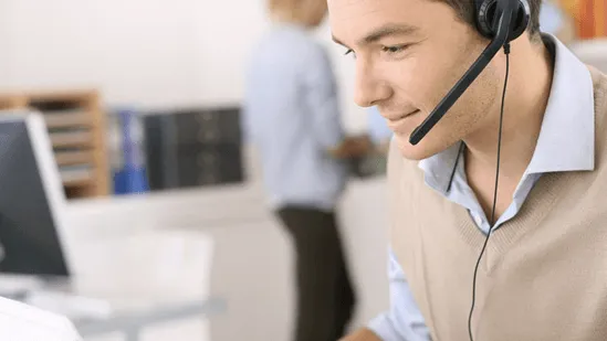 An Invoice Office support agent wearing a headset, helping a customer by phone